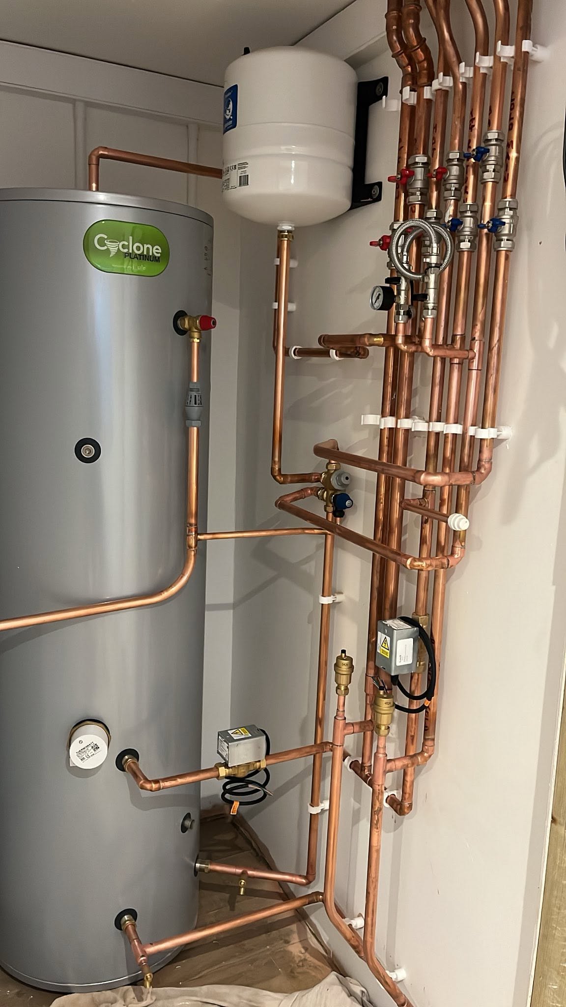 Unvented hot water cylinder and copper pipework installation